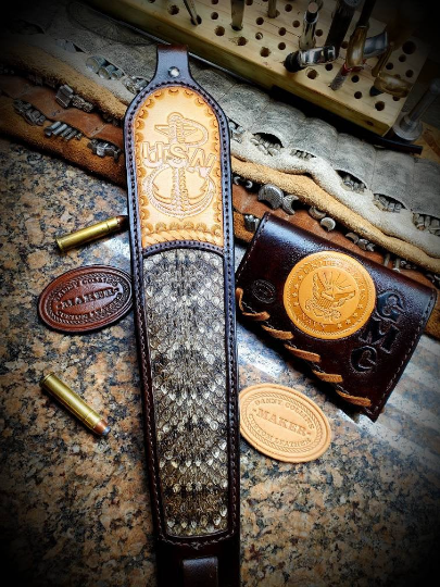 Custom leather rifle slings with tooled upper and rattlesnake inlay.